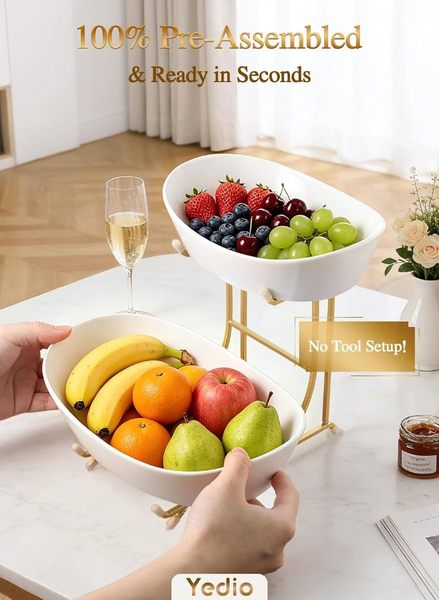 Yedio 2-tier ceramic fruit bowl in a bright kitchen holding citrus and apples in the lower bowl and berries and grapes in the elevated top tier.